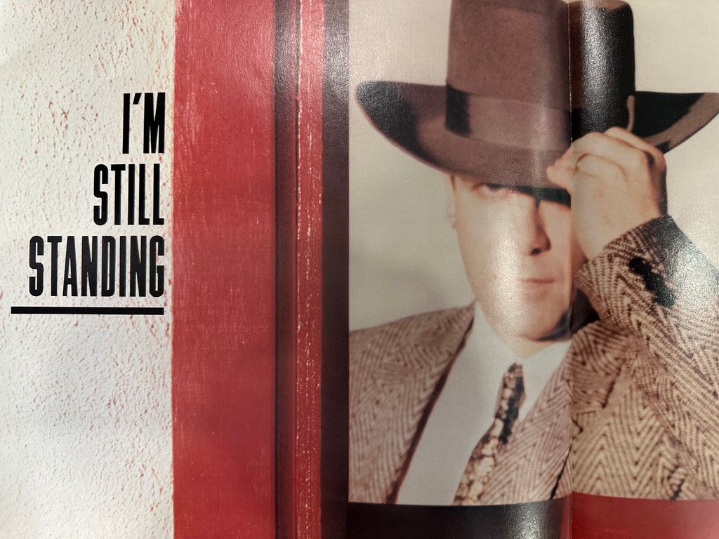 Elton John autographed program with pictures