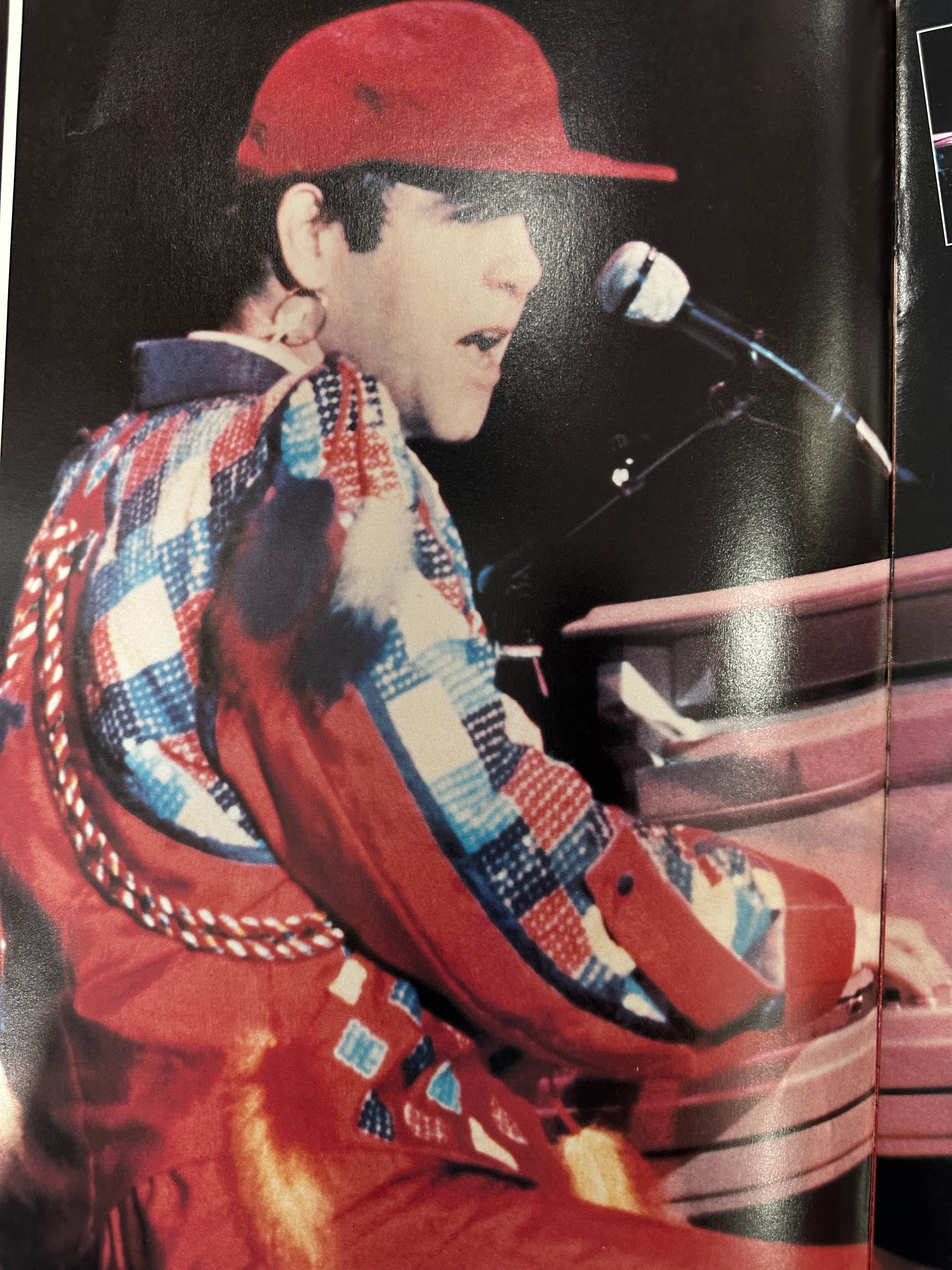 Elton John autographed program with pictures