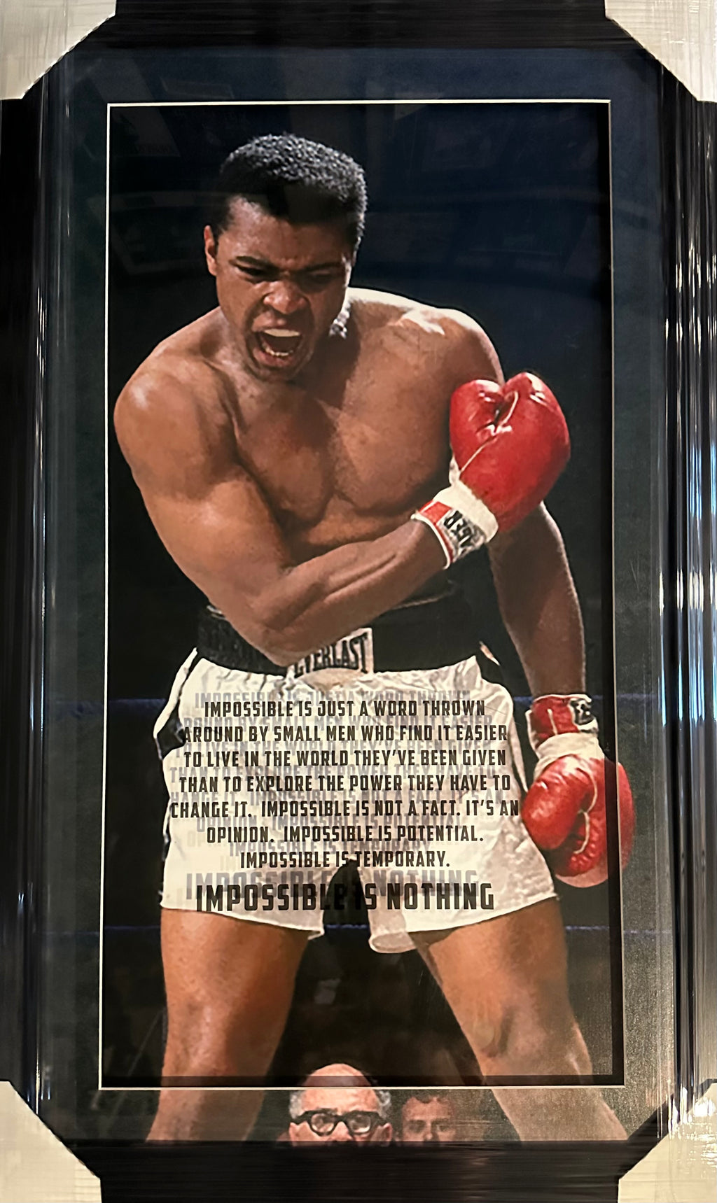 Muhammad Ali photo with "Impossible is Nothing" quote