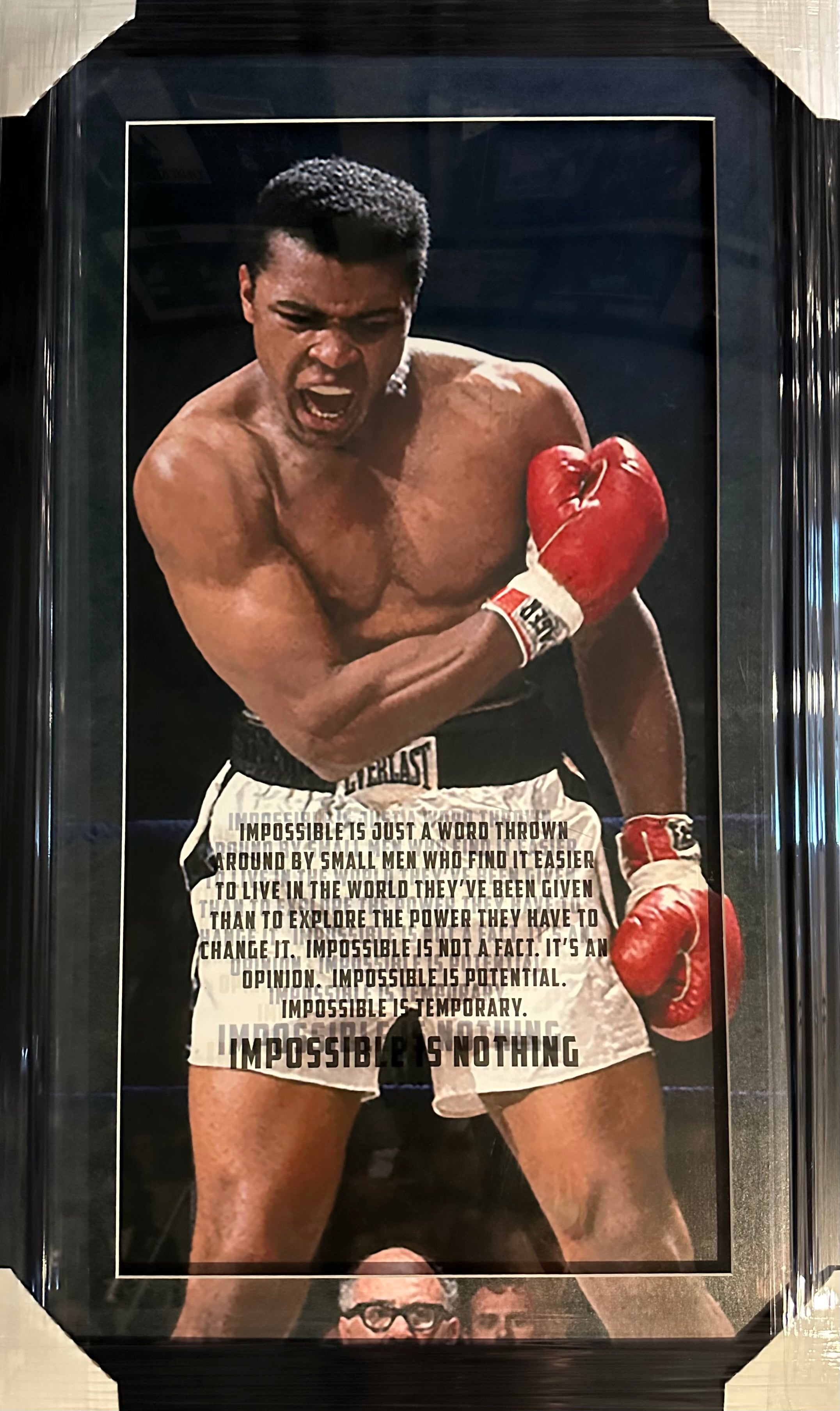 Muhammad Ali photo with "Impossible is Nothing" quote