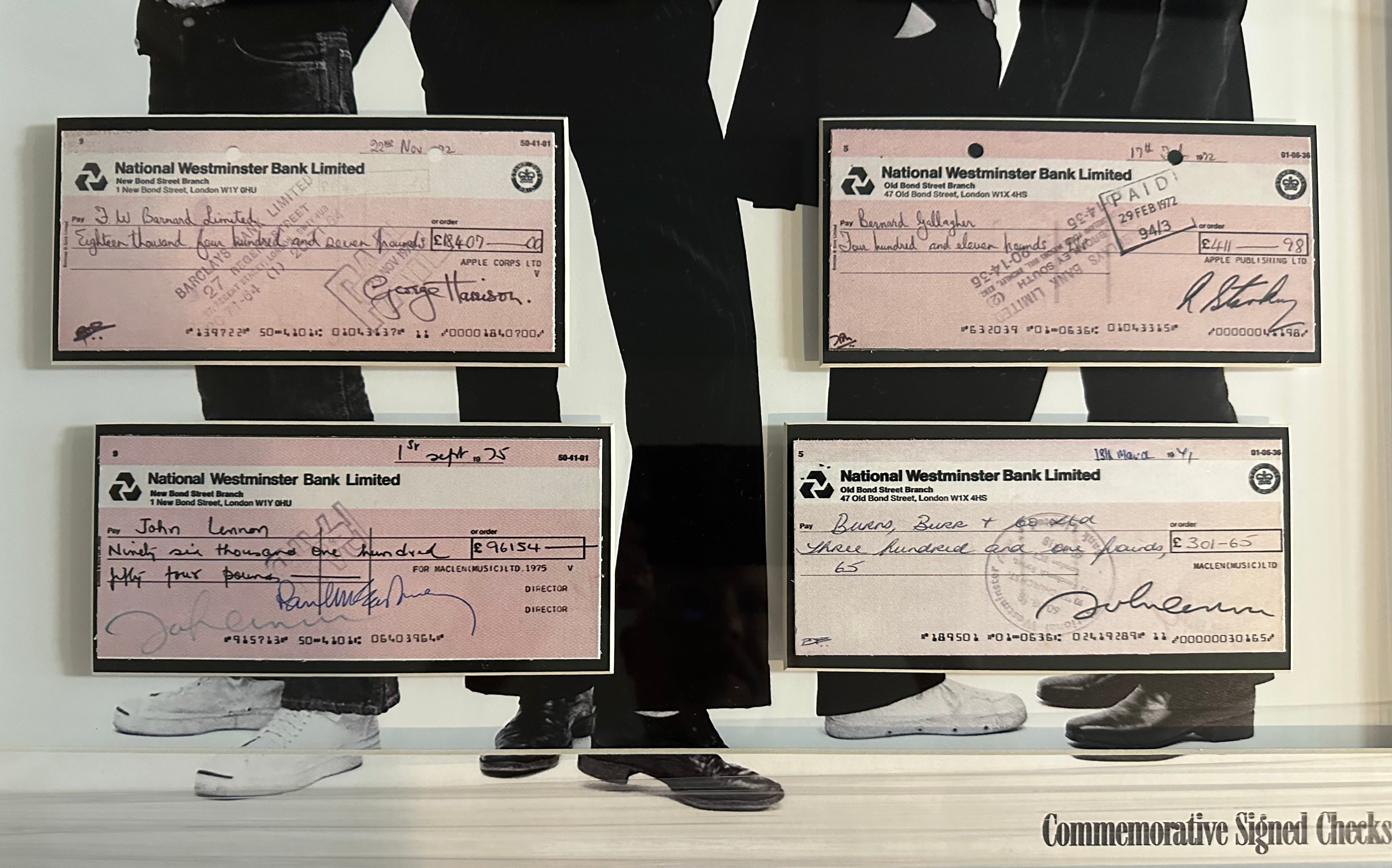 The Beatles with (Facsimile signed checks)