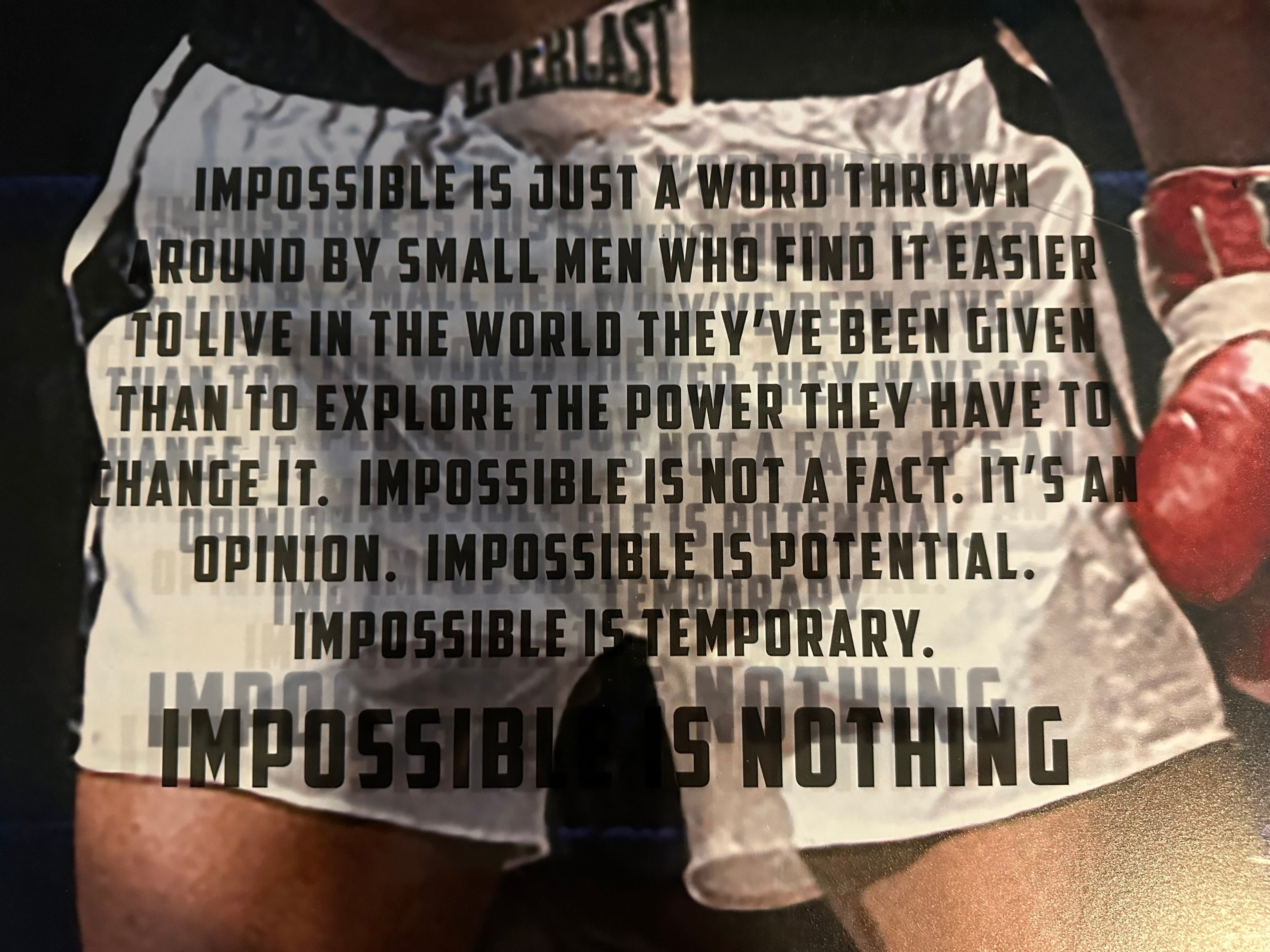 Muhammad Ali photo with "Impossible is Nothing" quote
