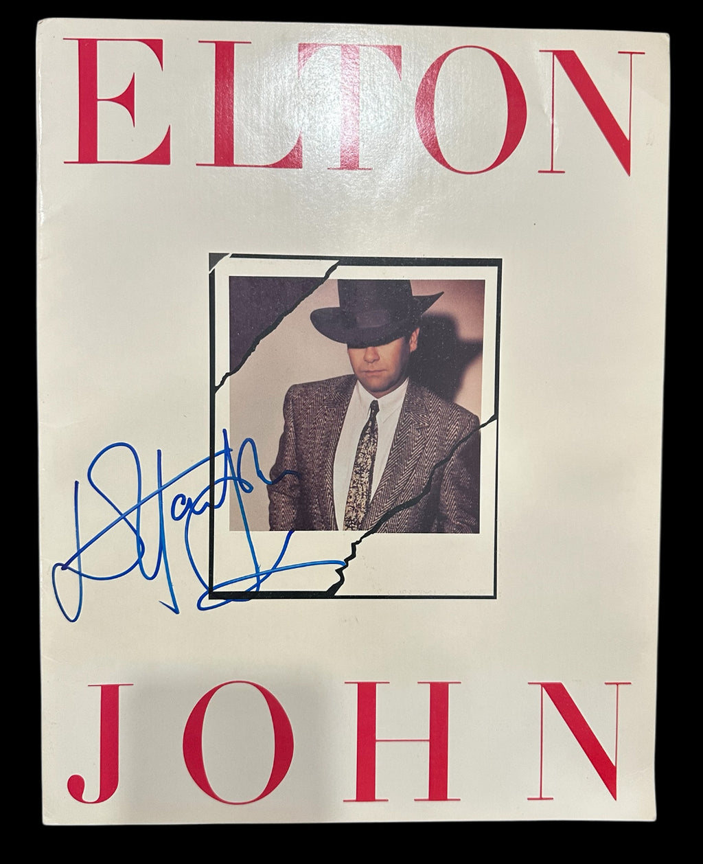 Elton John autographed program with pictures